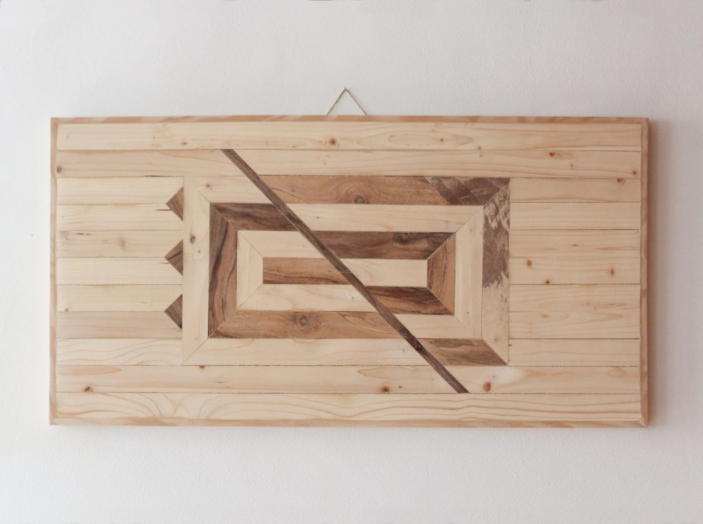 Wooden art piece to be hung on the wall. The design represents geometrically mirrors. We can see ourselves through the interaction with people, who are our mirrors.
